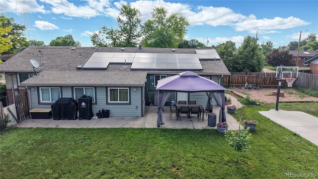41 S Fenton St, Lakewood, CO 80226 - back of house featuring roof mounted solar panels, a patio area, a gazebo, and a fenced backyard