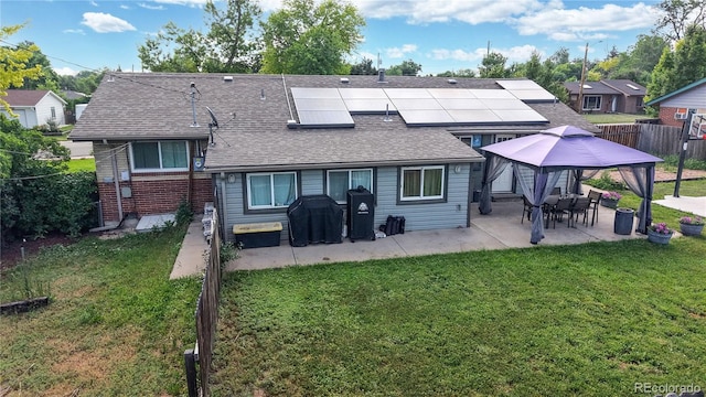 41 S Fenton St, Lakewood, CO 80226 - back of property featuring a gazebo, a patio area, roof mounted solar panels, a shingled roof, and brick siding