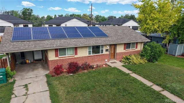41 S Fenton St, Lakewood, CO 80226 - view of front of property with brick siding, a shingled roof, solar panels, and concrete driveway