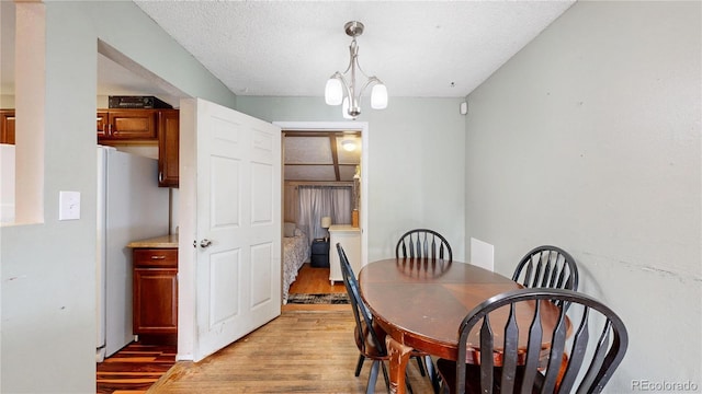 41 S Fenton St, Lakewood, CO 80226 - dining area with light wood-style floors and a textured ceiling