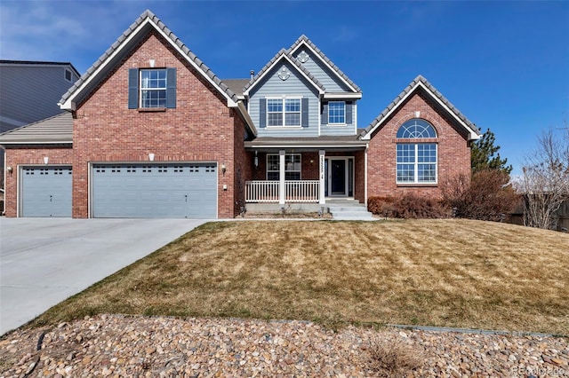 view of front of property featuring brick siding, a front lawn, a tile roof, concrete driveway, and covered porch