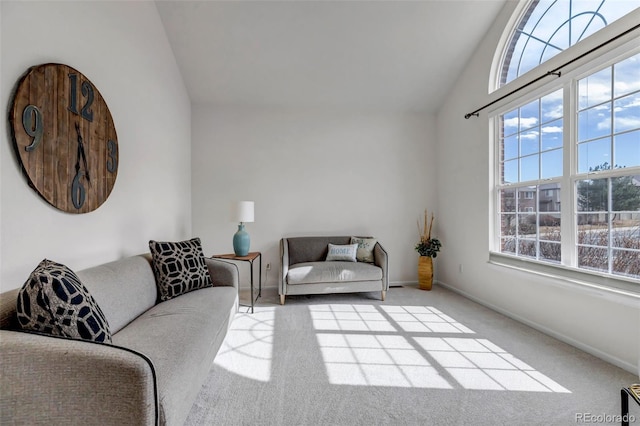 living area featuring carpet flooring, a healthy amount of sunlight, and baseboards