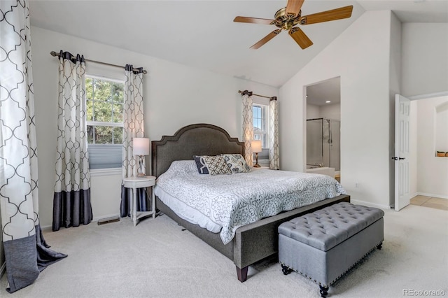 carpeted bedroom with multiple windows, a ceiling fan, connected bathroom, and high vaulted ceiling