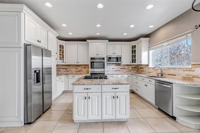 kitchen featuring white cabinets, appliances with stainless steel finishes, and a sink