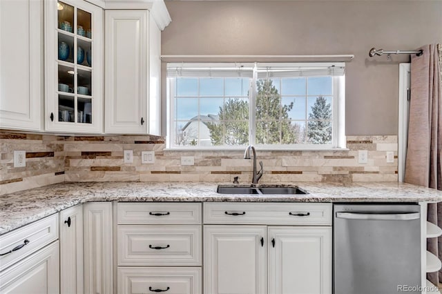 kitchen featuring a sink, glass insert cabinets, stainless steel dishwasher, and white cabinets