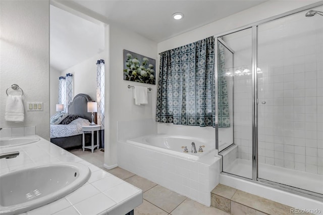 bathroom featuring a shower stall, tile patterned floors, a bath, ensuite bath, and a sink