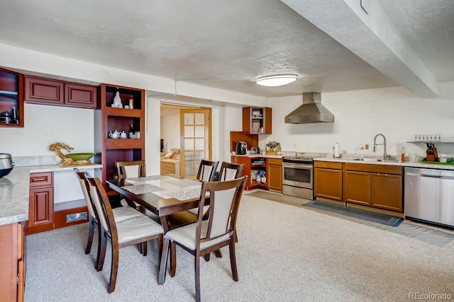 dining space with light colored carpet and a textured ceiling