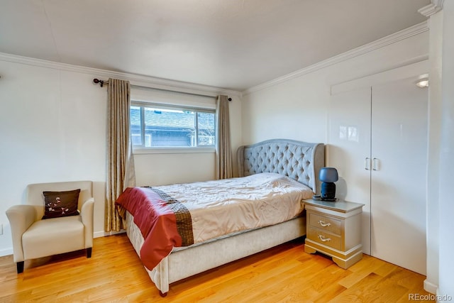 bedroom with light wood-style floors and ornamental molding