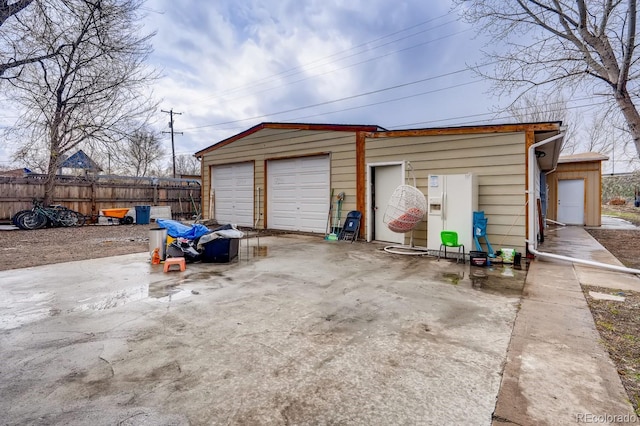 detached garage featuring fence