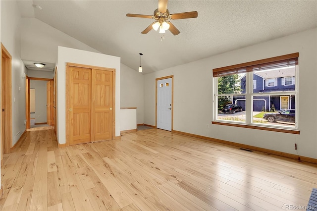 8376 Cobblestone St, Highlands Ranch, CO 80126 - unfurnished living room featuring lofted ceiling, ceiling fan, and light wood finished floors