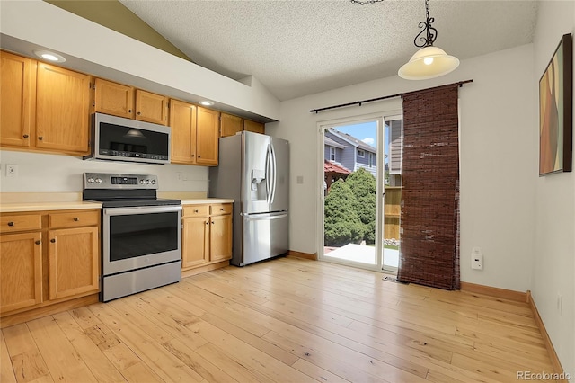 8376 Cobblestone St, Highlands Ranch, CO 80126 - kitchen with appliances with stainless steel finishes, lofted ceiling, light countertops, a textured ceiling, and pendant lighting