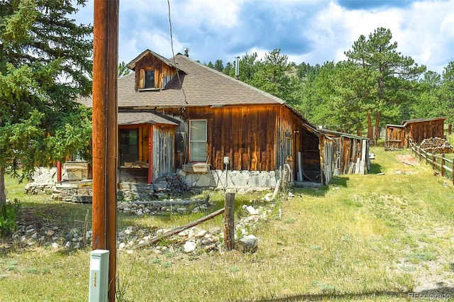 rear view of property featuring a yard