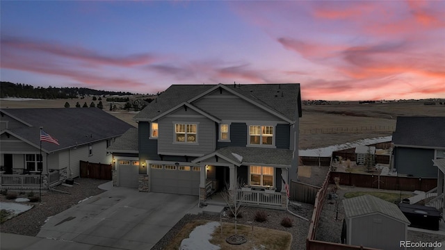 view of front of house with covered porch and a garage