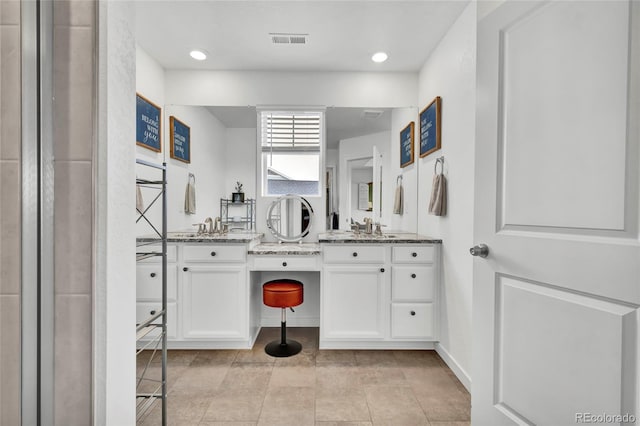 bathroom with tile patterned flooring and vanity