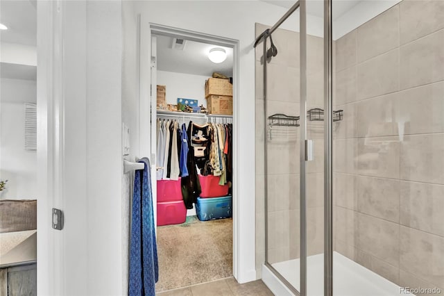 bathroom with tile patterned floors and walk in shower