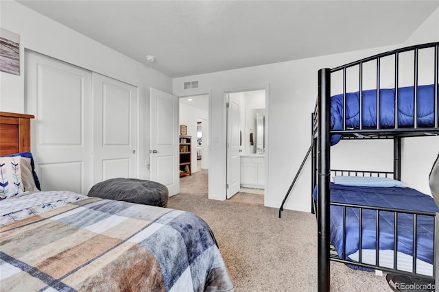 bedroom with light carpet, connected bathroom, and a closet