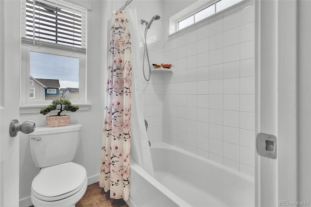 bathroom featuring shower / tub combo and toilet