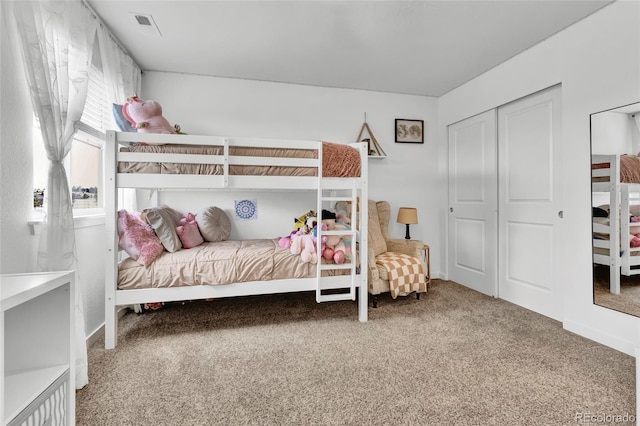 bedroom with carpet and a closet