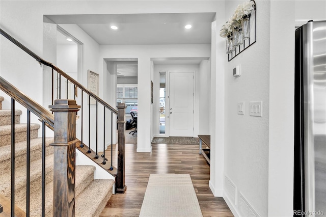 foyer entrance featuring dark wood-type flooring