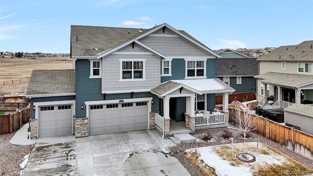 view of front of home with covered porch and a garage