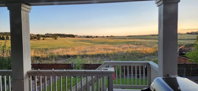 yard at dusk featuring a rural view