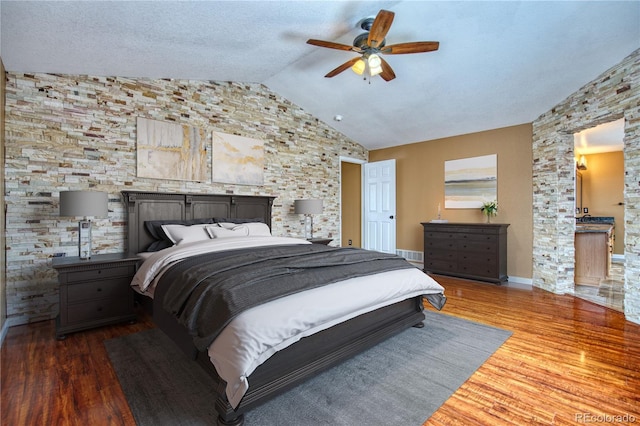 bedroom featuring hardwood / wood-style floors, ceiling fan, and lofted ceiling