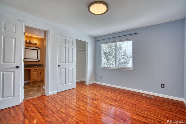 unfurnished bedroom with light hardwood / wood-style flooring and a closet