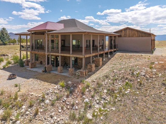 16985 County Road 306, Buena Vista, CO 81211 - back of property featuring a patio area and stone siding