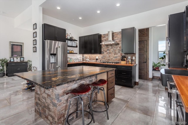 16985 County Road 306, Buena Vista, CO 81211 - kitchen featuring appliances with stainless steel finishes, wall chimney range hood, open shelves, tasteful backsplash, and a center island