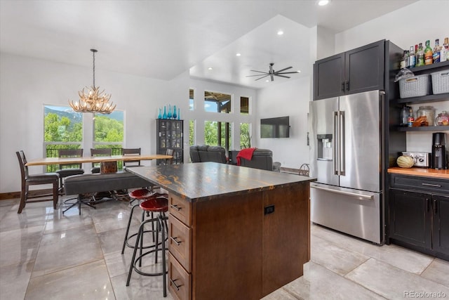 16985 County Road 306, Buena Vista, CO 81211 - kitchen with high end fridge, a kitchen island, dark countertops, recessed lighting, and a breakfast bar area