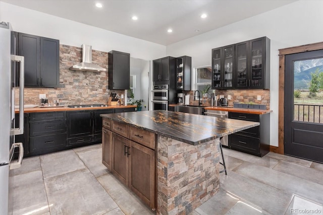 16985 County Road 306, Buena Vista, CO 81211 - kitchen featuring wall chimney range hood, stainless steel appliances, tasteful backsplash, a center island, and recessed lighting