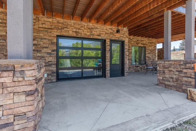 16985 County Road 306, Buena Vista, CO 81211 - view of exterior entry featuring stone siding and a patio