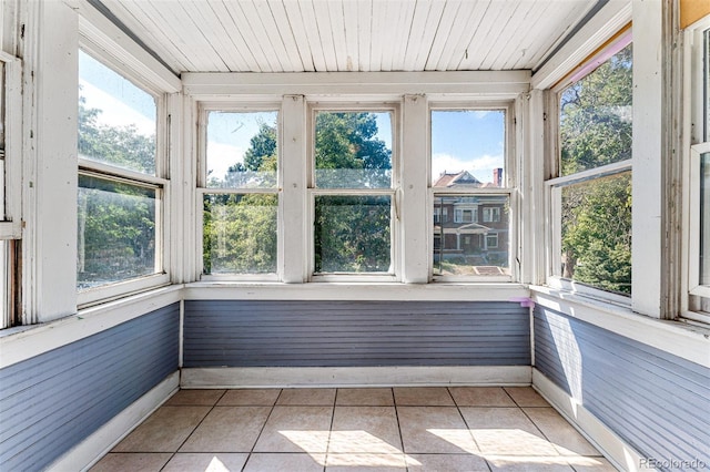 unfurnished sunroom with wood ceiling and a healthy amount of sunlight