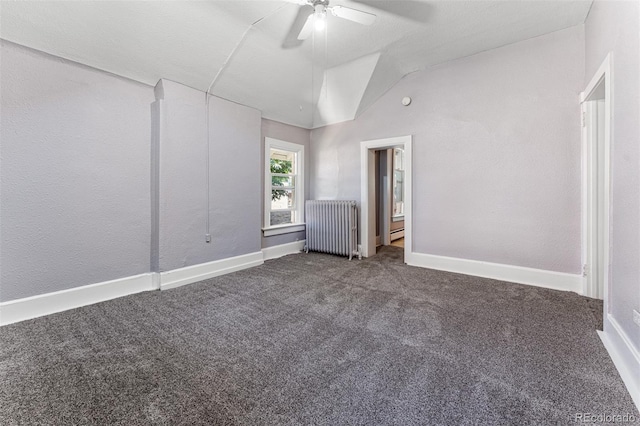 interior space featuring carpet, baseboards, vaulted ceiling, and radiator heating unit