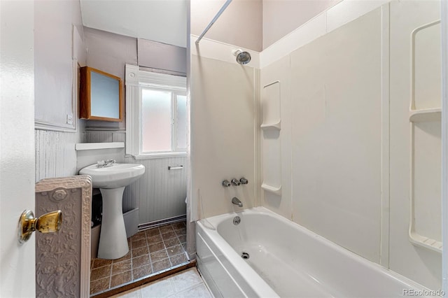 bathroom featuring shower / bath combination, a sink, and tile patterned floors