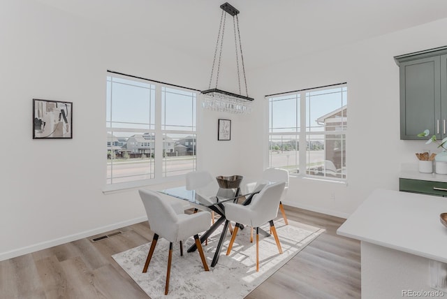14345 Dahlia St, Thornton, CO 80602 - dining space with light wood-style flooring and baseboards