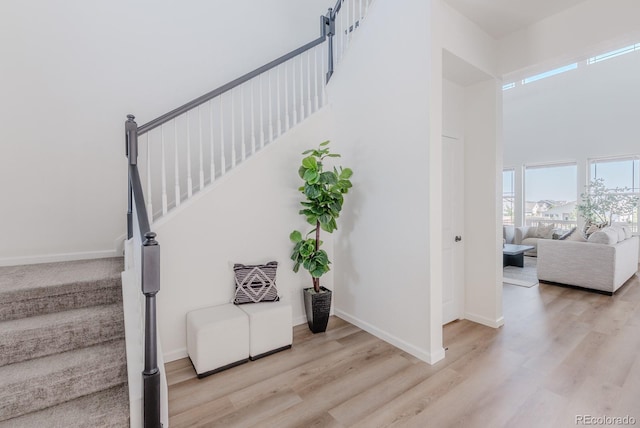 14345 Dahlia St, Thornton, CO 80602 - staircase featuring wood finished floors and a towering ceiling