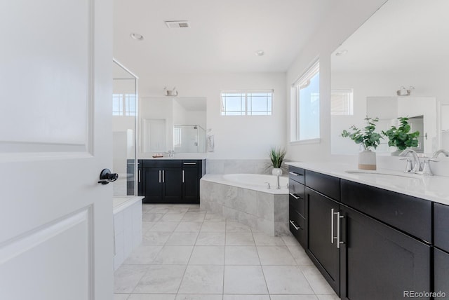14345 Dahlia St, Thornton, CO 80602 - bathroom with vanity, a garden tub, a stall shower, and tile patterned flooring