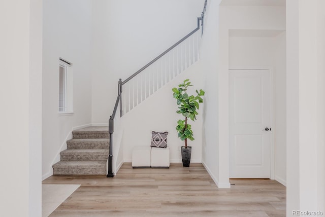 14345 Dahlia St, Thornton, CO 80602 - stairs with wood finished floors and a towering ceiling