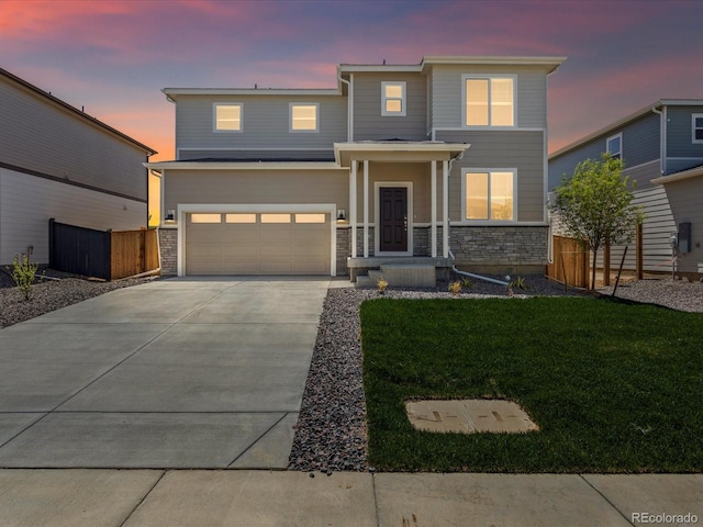 7324 27th Street Ln, Greeley, CO 80634 - view of front of house with a garage, concrete driveway, and stone siding