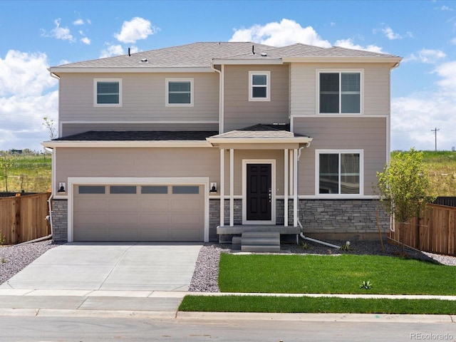 7324 27th Street Ln, Greeley, CO 80634 - view of front of house with stone siding, concrete driveway, and a garage