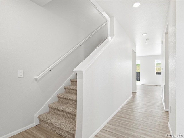 7324 27th Street Ln, Greeley, CO 80634 - stairway with wood finished floors, baseboards, and recessed lighting