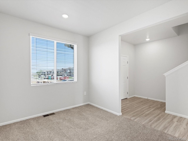 7324 27th Street Ln, Greeley, CO 80634 - unfurnished room with baseboards, recessed lighting, and light carpet