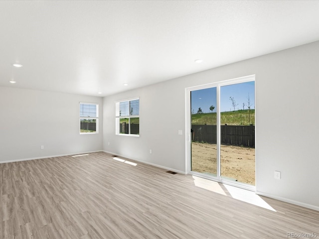 7324 27th Street Ln, Greeley, CO 80634 - empty room with recessed lighting, light wood-style flooring, and baseboards