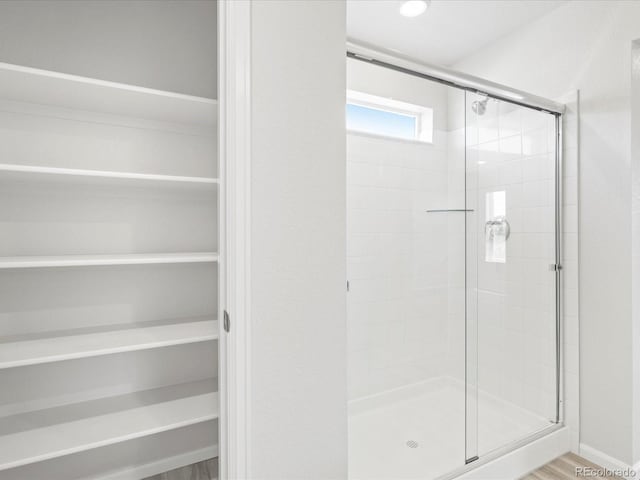 7324 27th Street Ln, Greeley, CO 80634 - bathroom with a shower stall and wood finished floors