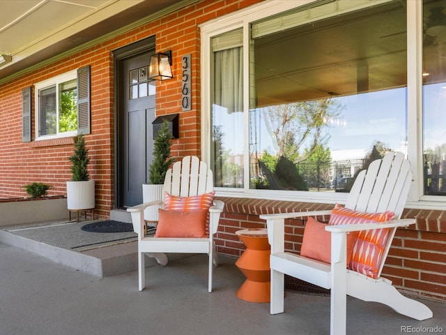 3560 S Glencoe St, Denver, CO 80237 - doorway to property featuring brick siding and a porch