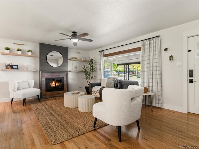 3560 S Glencoe St, Denver, CO 80237 - living room with wood finished floors, a glass covered fireplace, a ceiling fan, and baseboards