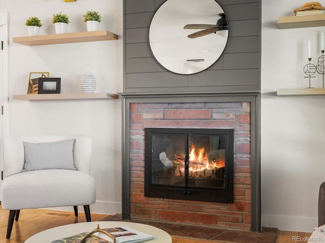 3560 S Glencoe St, Denver, CO 80237 - detailed view of baseboards, a ceiling fan, a glass covered fireplace, and wood finished floors