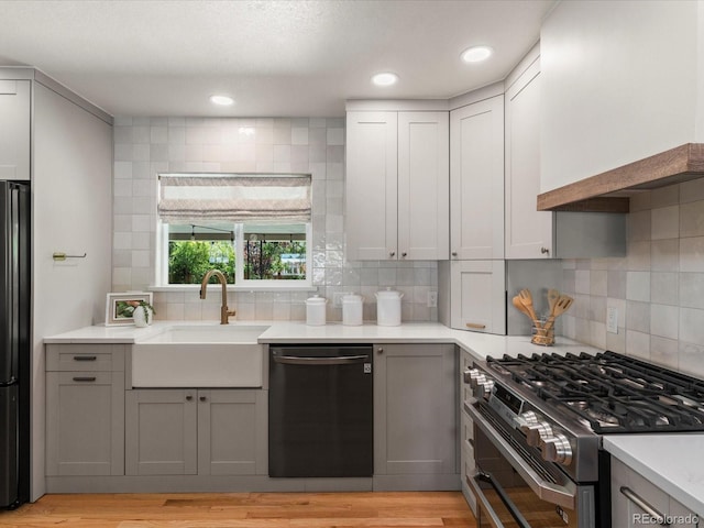 3560 S Glencoe St, Denver, CO 80237 - kitchen with dishwasher, range with two ovens, a sink, backsplash, and recessed lighting