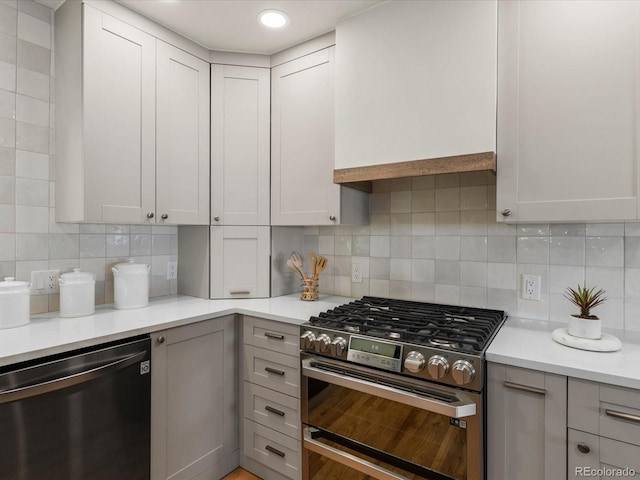 3560 S Glencoe St, Denver, CO 80237 - kitchen featuring stainless steel appliances, light countertops, tasteful backsplash, and gray cabinets